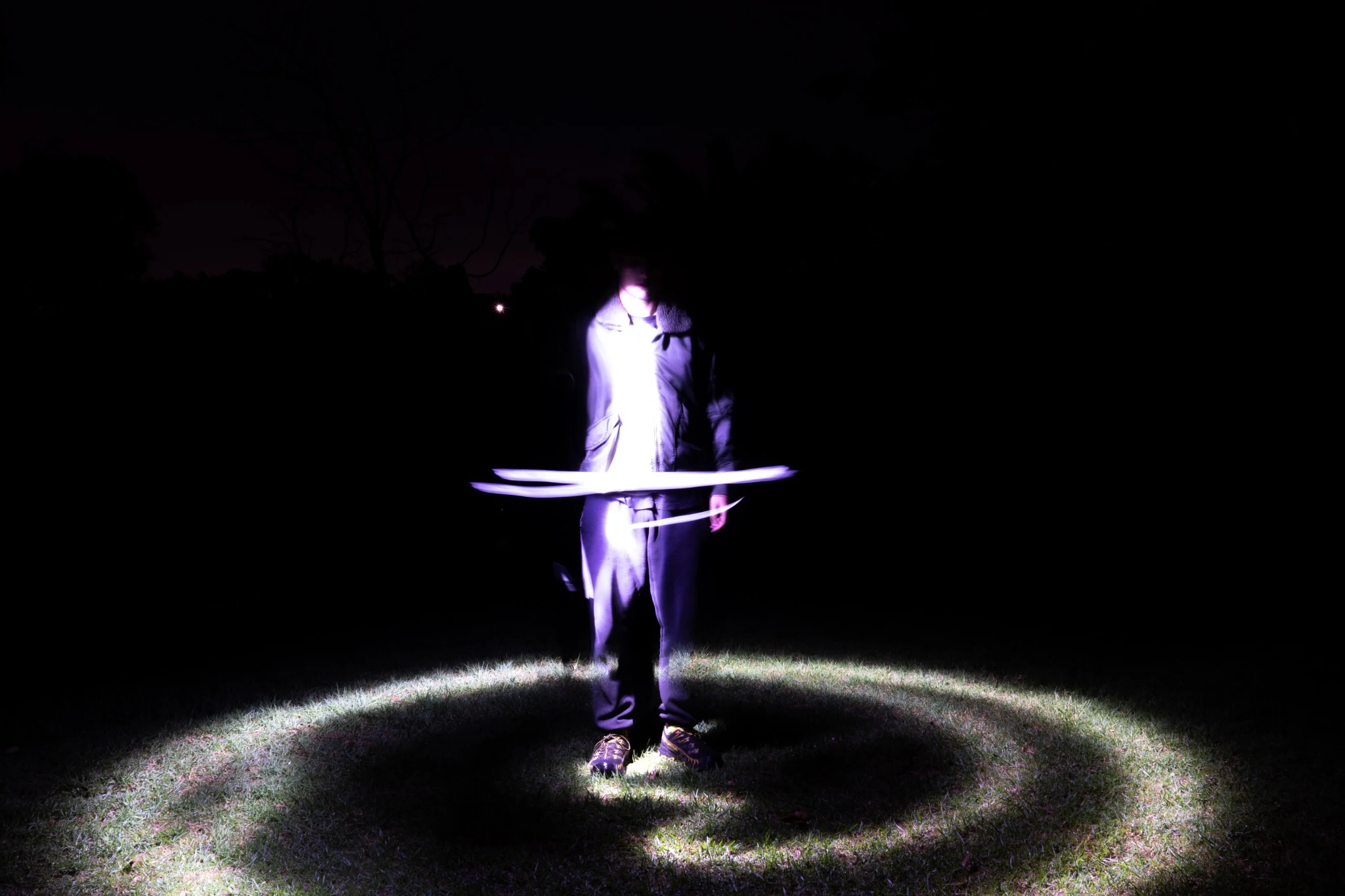 Standing figure inside a glowing purple light ring