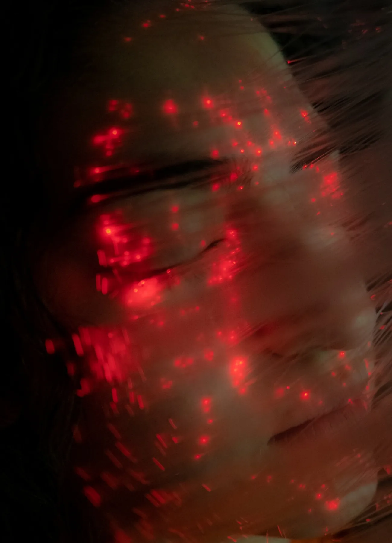 Red fiber optic light over face